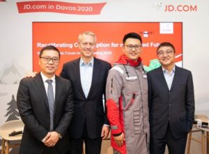 Coca-Cola Chairman and CEO James Quincey(second left), JD Retail CEO Lei Xu(far right), JD Logistics CEO Zhenhui Wang(far left) with a model who wears a JD Courier’s uniform made by recycled beverage bottles, at World Economic Forum in Davos in January, 2020. 