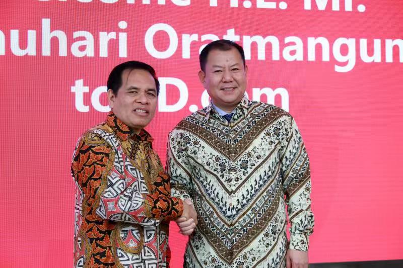 Indonesian ambassador Djauhari Oratmangun (L) shakes hand with Yan Xiaobing (R) , senior VP of JD and president of JD International Business