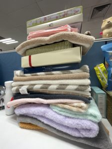The pile of different kinds of towels on Pu’s desk